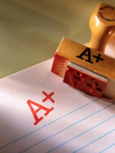 Red A+ stamp on lined notebook paper