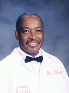 Smiling man wearing white coat and bow tie